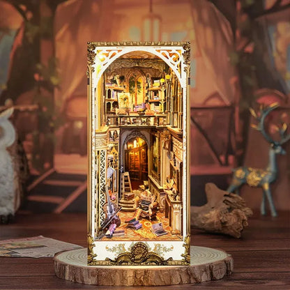 A detailed miniature model of a baroque-style room with intricate decorations and a golden frame, displayed on a wooden stand.